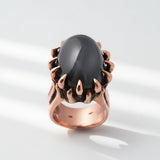 A rose gold ring with a black onyx nest design, set with a total weight of 31.00 carats.